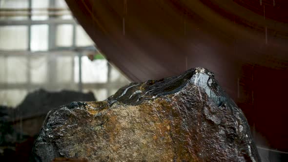 Large Industrial Stone Cutter Cuts Granite Rock Into Plates in Jets of Water Close Up alt