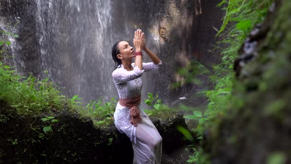 Sensible Elegant Woman Praying in the Tropical Jungles Rainbow in the Waterfall Beauty in Nature alt