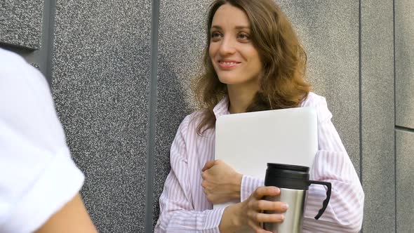 Female Portrait of Young Woman with Silver Laptop and Cup of Coffee Waiting for a Meeting Near Dark alt