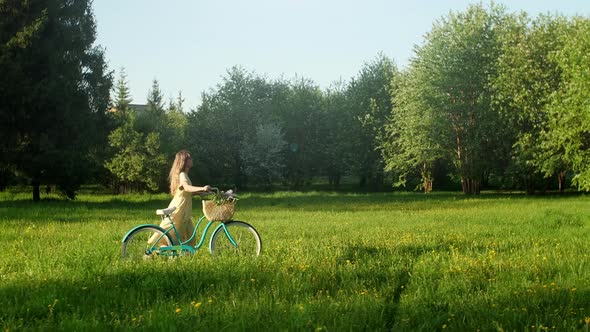 Cyclist Woman Walk With Bicycle On Countryside Road At Summer Time alt