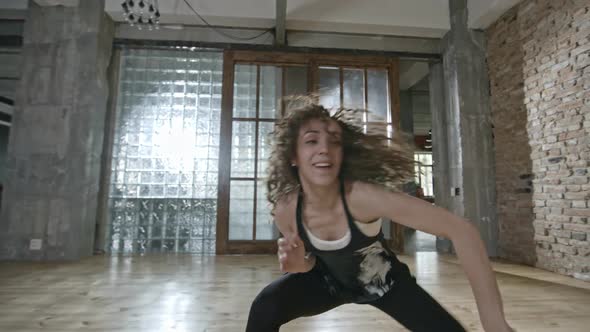Energetic Woman Dancing in Loft alt