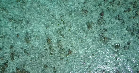 Wide overhead abstract view of a white sandy paradise beach and aqua blue ocean background in high r alt