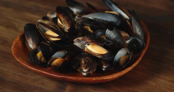 Delicious Mussels on a Plate on the Table.  alt