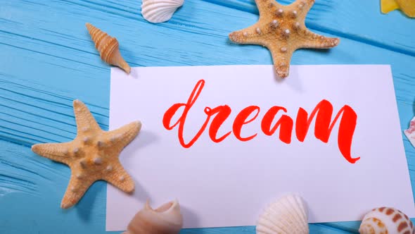 Dream text. Font of lettering motivational word on white canvas with red ink by calligrapher.  alt