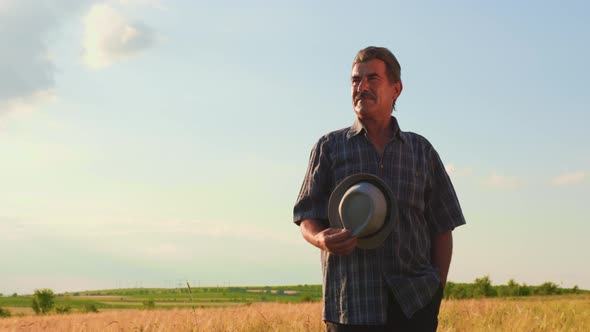 Senior Male Brazilian Farmer Takes His Hat Off alt