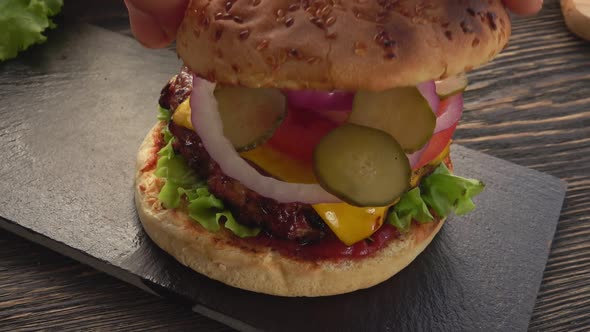 Top View of the Grilled Sesame Bun is Placed on a Fresh Homemade Grilled Burger alt