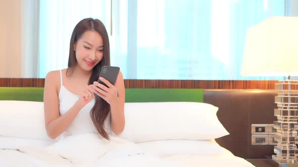 Young asian woman use smart phone alt