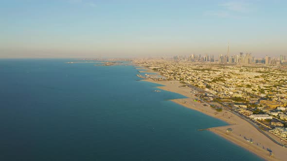 Aerial view of Dubai sea coast beach with downtown skyline, bay in United Arab Emirates or UAE.