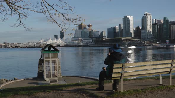 Man filming the Vancouver Cannon Blasts in Stanley Park alt