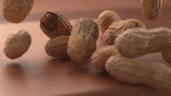 Peanuts falling onto wooden surface in super slow motion.  Shot on Phantom Flex 4K high speed camera