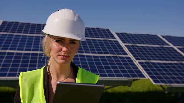 Female Ecological Engineer Uses Digital Tablet and Collects Efficient Information About Solar Panels