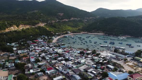 A village under the mountains is located near VInh Hy bay. Fishermen's boats are anchored along the alt