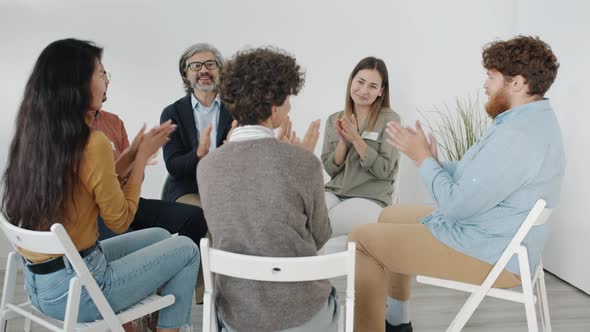 Diverse Group of People Clapping Hands and Smiling Then Leaving Therapy Session alt