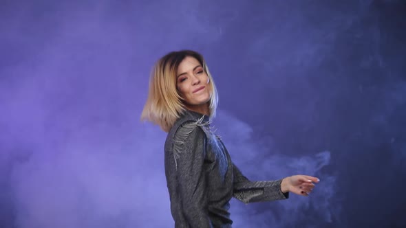 Woman in Casual Clothes Dancing on Color Background