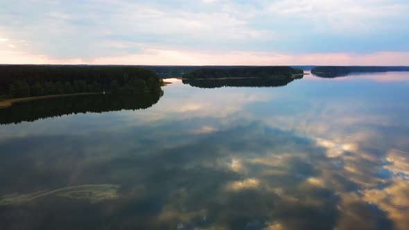 Aerial Shot of Lake Sunset and Sunset Sky Reflecting in Water. Lake Wdzydze, Kashubia, Poland.
