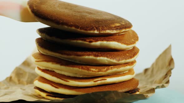 Another pancake is placed on a stack of pancakes alt