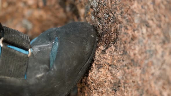 Extreme Close  Up of the Toe of a Rock Shoe Stepping on a Rock Ledge
