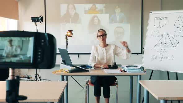 Maths Teacher Is Having an Online Lesson with Adult Students alt