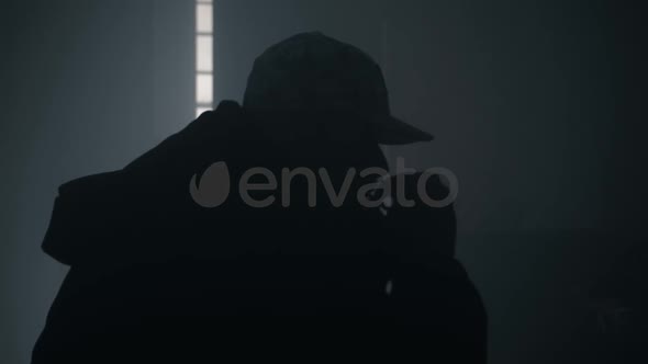 Silhouette Of Man Smoking Cigarette Or Drugs alt