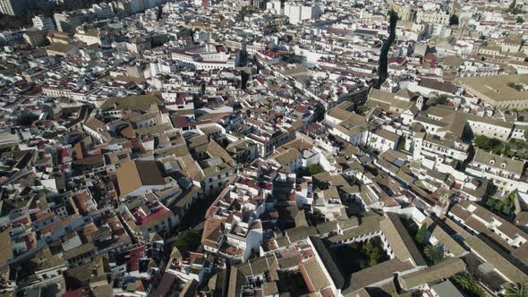 Drone flying over roofs of Cordoba city in Spain. Aerial top-down reverse