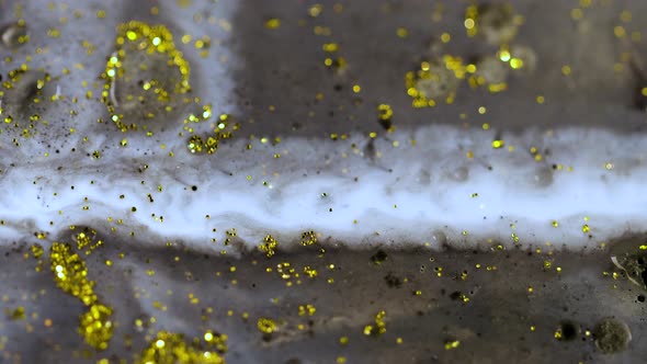 Macro Close Up Shot Of Golden Wet Glitter. Golden Space Glittering Particle Background.  alt