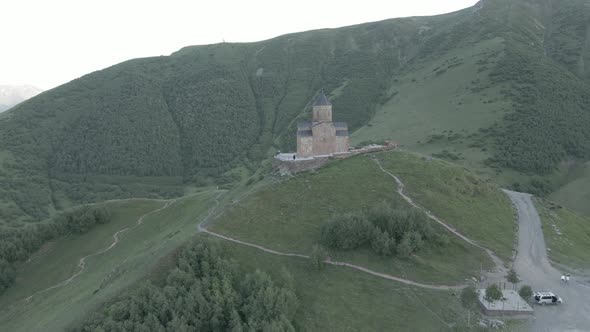 Stepantsminda, Georgia - May 8 2021: Aerial view of Gergeti Trinity Church, Tsminda Sameba. Kazbegi alt