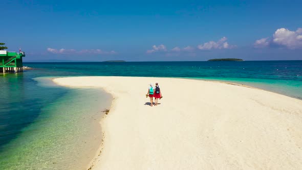 Girls Tourists Strolling on a Tropical Beach. Perfect White Sand Beach, View From Above. alt