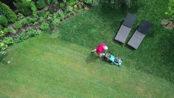 Video Footage of a Man Mowing the Lawn