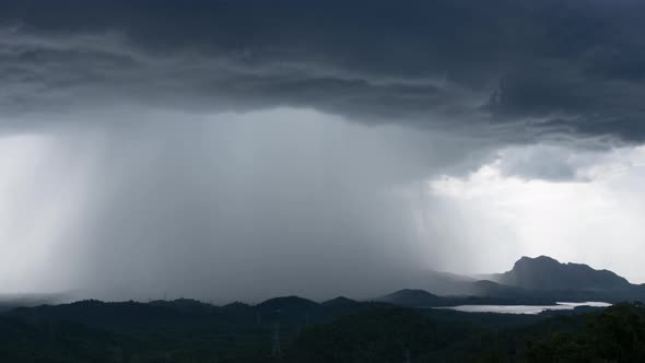 Rain storms and black clouds moving over the mountains.