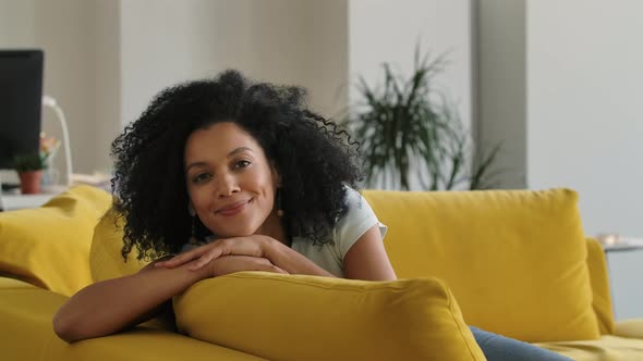 Portrait of a Young African American Woman Looking at the Camera and Smiling Cute alt