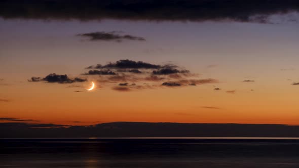 Time lapse shot of moonset after sunset in Batumi, Georgia alt