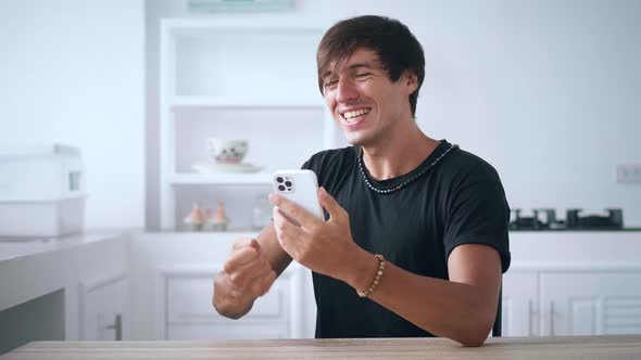 Excited Man Looking at Smartphone Celebrate Success Mobile Win Online Bet alt