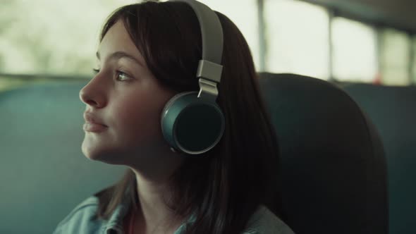 Girl Teenager Traveling Bus with Headphones Close Up alt