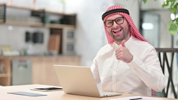 Thumbs Up By Positive Young Arab Businessman Working in Office  alt
