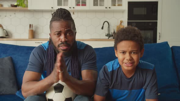 African Family of Football Fans Watching Game on Tv Indignant By Foul Committed alt