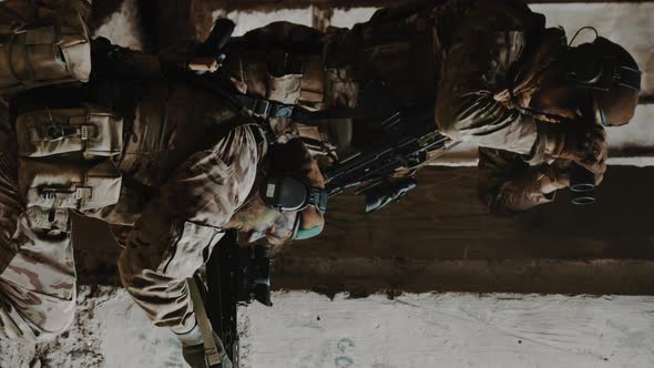 Vertical Shot Soldier with Binoculars Scanning the Positions of the Enemy alt