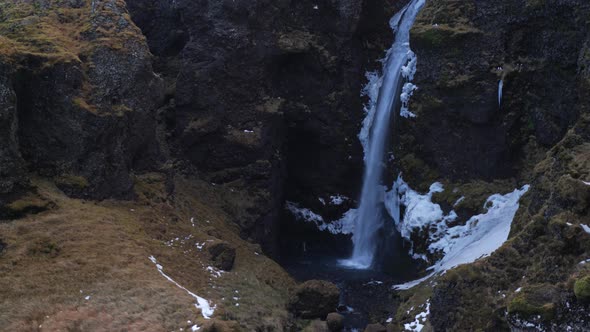 Iceland Tilt Up To Reveal Tall Waterfall On Moss Covered Mountain 1