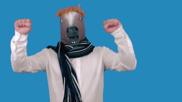 A man with a horse's head is dancing on a blue background.