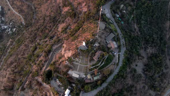Aerial top down spinning over Sanctuary of the Immaculate Conception and statue in San Cristobal Hil alt