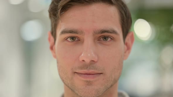 Close Up of Face of Creative Young Man Looking at the Camera alt