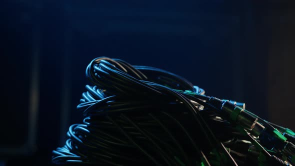 Closeup of a Man's Hand That Takes a Bunch of XLR Wires alt