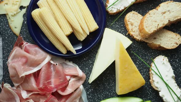 Cold appetizer. Cold cuts. Spicy food on black background, top view