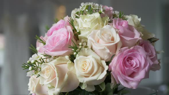 Bridal flowers wedding bouquet (Pink, white and coral pastel) on a table in slow motion. alt