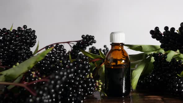 Medicine In A Jar On A Wooden Board, A Bottle Of Medicine From A Black Berry. Elderberry Homeopathy alt