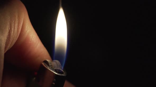 Close Up Slow Motion Shot of Lighter on the Man Hand alt