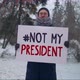 Man with a sign #Not My President posing for social media attention in a park - VideoHive Item for Sale