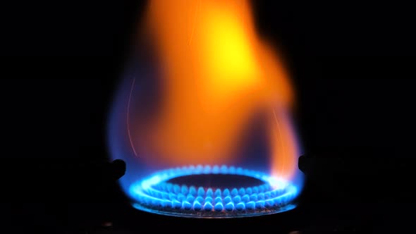 Gas Stove Being Turned on Isolated on Black Background