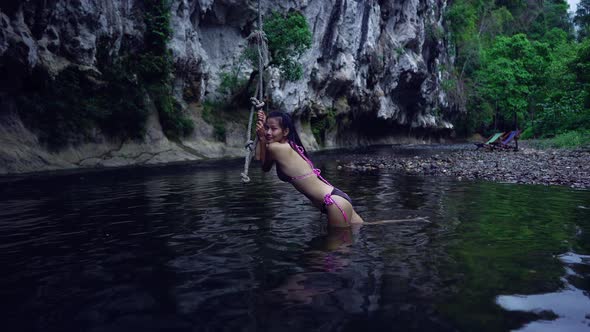 Cute Asian Girl in Bikini Chilling By a Rope in the River Thailand