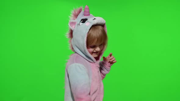 Little Blonde Child Girl Smiling Dancing Celebrating in Unicorn Pajamas Costume on Chroma Key alt