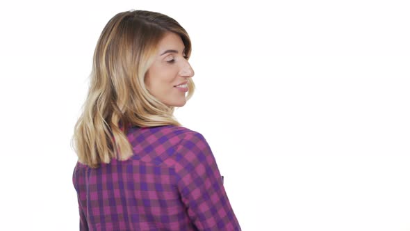 Portrait From Back of Cute Young Woman with Dyed Blond Hair Turning Around Looking at Camera Smiling alt